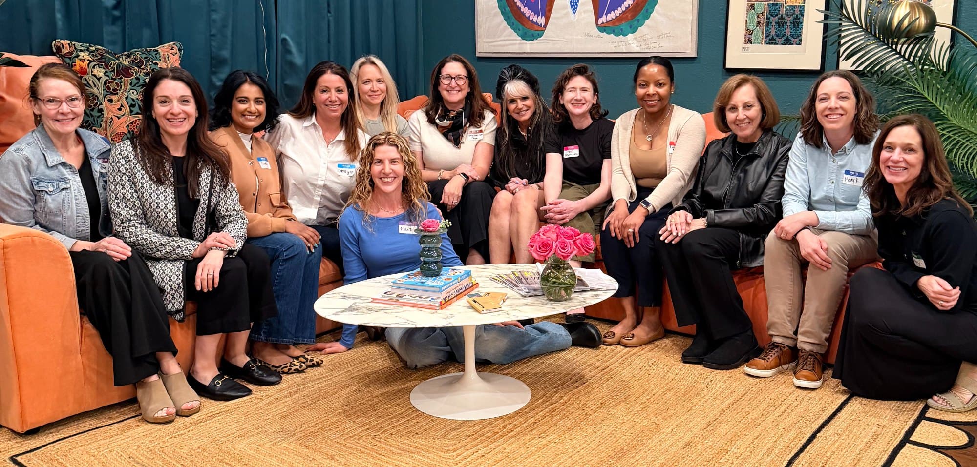 Founding meeting of the Michigan Menopause Collaborative — practitioners seated together in a teal-walled Birmingham room, beneath a butterfly painting.